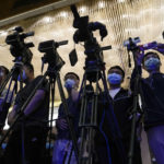 
              Video journalists film a news conference chaired by Zhu Tao, Director of Aviation Safety, Civil Aviation Administration of China, Sun Shiying, Chairman of China Eastern Airlines Yunnan Co., LTD and other officials following the China Eastern plane crash, at a hotel in Wuzhou, in southwestern China's Guangxi province, Tuesday, March 22, 2022. A China Eastern flight 5735 carrying 123 passengers and nine crew members crashed outside the city of Wuzhou in the Guangxi region while flying from Kunming, the capital of the southwestern province of Yunnan, to Guangzhou, an industrial center not far from Hong Kong on China's southeastern coast. It ignited a fire big enough to be seen on NASA satellite images before firefighters could extinguished it. (AP Photo/Ng Han Guan)
            
