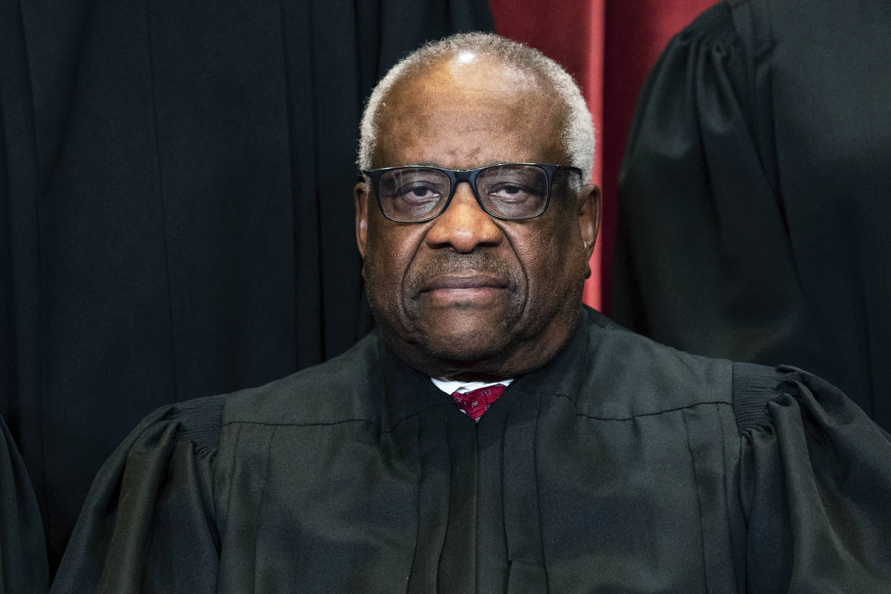 FILE - Justice Clarence Thomas sits during a group photo at the Supreme Court in Washington, on Fri...