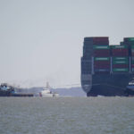 
              The tugboats Atlantic Enterprise, left, and Atlantic Salvor, bottom right, use lines to pull the container ship Ever Forward, top right, which ran aground in the Chesapeake Bay, as crews began to attempt to refloat the ship, Tuesday, March 29, 2022, in Pasadena, Md. (AP Photo/Julio Cortez)
            