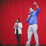 
              In this image provided by Hope Chicago, Pete Kadens, Hope Chicago co-founder, shares the stage with Dr. Janice Jackson, CEO of Hope Chicago, where they announced on Feb. 25, 2022, that the entire student body, 503 students total, at Farragut Career Academy High School in Chicago, were receiving full, debt-free college scholarships to partner colleges and universities. (Hope Chicago via AP)
            