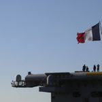 
              French Navy officers stand onboard the Charles de Gaulle aircraft carrier, off the shore of the Faliro suburb, in Athens, Greece, Thursday, March 24, 2022. Greece signed agreements with France and two French contractors worth some 4 billion euros ($4.4 billion) to purchase three navy frigates and six additional Rafale fighter jets, as Athens continues to strengthen its armed forces in response to tension with neighbor Turkey. (Costas Baltas/Pool via AP)
            