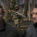 
              A Ukrainian serviceman guards the area as Kyiv Mayor Vitali Klitschko, right, speaks during a press conference next to his brother, former heavyweight boxing world champion Wladimir Klitschko, in Kyiv, Ukraine,Wednesday, March 23, 2022. From a public park in the city, Klitschko said 264 civilians had so far died from Russian bombardment on the capital, including four children. As he spoke to reporters, explosions and loud gunfire echoed across the city. (AP Photo/Vadim Ghirda)
            