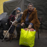 
              Evacuated neighbours from Irpin gather in an assistant center on the outskirts of Kyiv, Ukraine, Wednesday, March 30, 2022. (AP Photo/Rodrigo Abd)
            