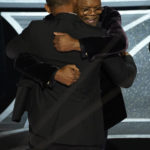 
              Will Smith, left, and Samuel L. Jackson hug in the audience as Will Smith is announced the winner of the award for best performance by an actor in a leading role for "King Richard" at the Oscars on Sunday, March 27, 2022, at the Dolby Theatre in Los Angeles. (AP Photo/Chris Pizzello)
            