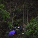 
              Soldiers eat their meals near the crashed site of the China Eastern Flight 5735, Thursday, March 24, 2022, in Molang village, in southwestern China's Guangxi province. The search area was expanded Thursday in a "blanket search" for the second black box from a China Eastern passenger plane that crashed in southern China with 132 people on board earlier this week, state media said. (AP Photo/Ng Han Guan)
            