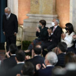
              Portuguese Prime Minister Antonio Costa, left, is applauded after delivering his speech closing the swearing in ceremony of the new center-left Socialist government at the Ajuda palace in Lisbon, Wednesday, March 30, 2022. The Socialists captured 120 seats in the 230-seat parliament in a landslide election win last January, opening a path for far-reaching reforms long postponed by political quarreling. (AP Photo/Armando Franca)
            