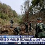 
              In this image taken from video footage run by China's CCTV, soldiers conduct search operations at the site of a plane crash in Tengxian County in southern China's Guangxi Zhuang Autonomous Region, Tuesday, March 22, 2022. Mud-stained wallets. Bank cards. Official identity cards. Some of the personal effects of 132 lives presumed lost were lined up by rescue workers scouring a remote mountainside Tuesday for the wreckage of a China Eastern plane that one day earlier inexplicably fell from the sky and burst into a huge fireball. (CCTV via AP Video)
            