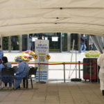 
              Medical workers wait for people at a temporary COVID-19 testing center in Seoul, South Korea, Friday, April 15, 2022. South Korea will remove most pandemic restrictions, including indoor gathering limits, as it slowly wiggles out of an omicron outbreak officials say is stabilizing. (AP Photo/Ahn Young-joon)
            