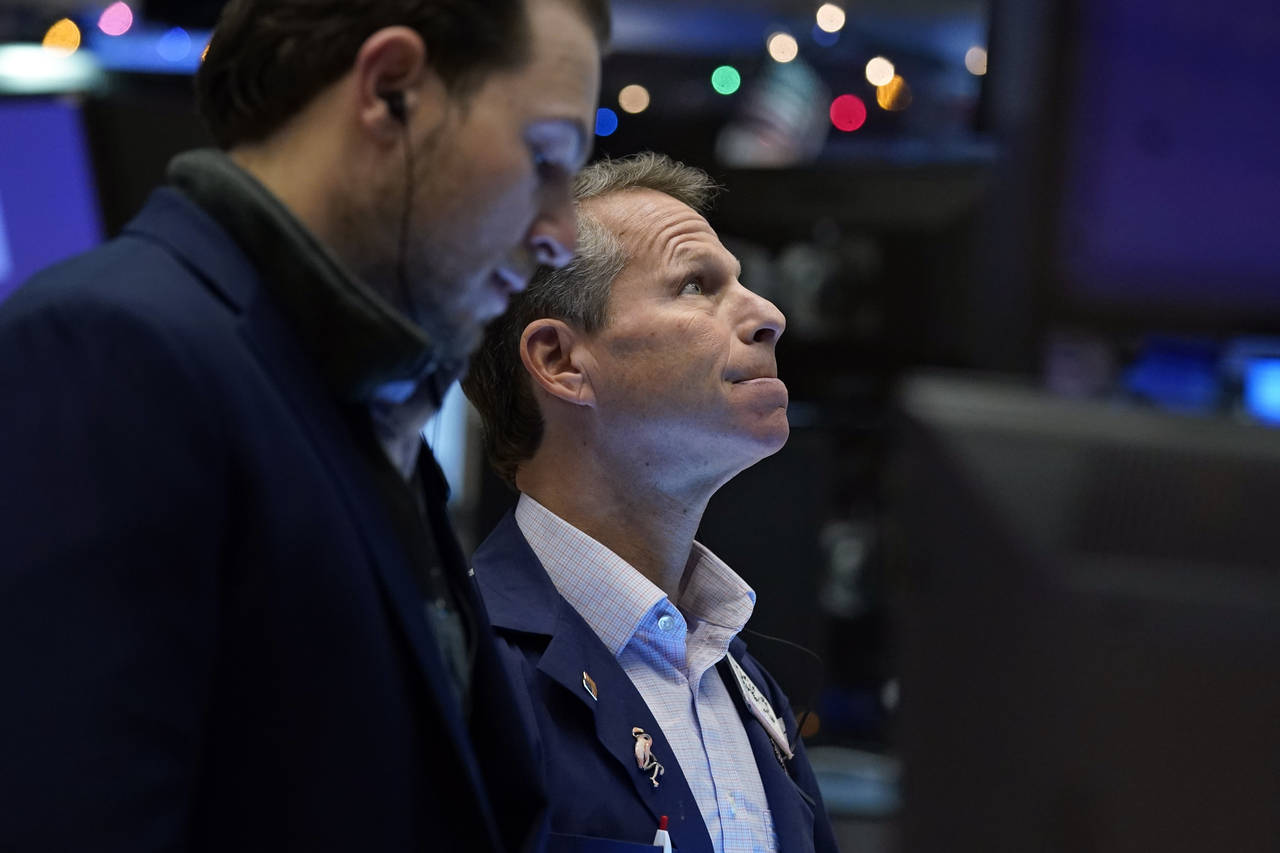 FILE - Trader Robert Charmak, right, works on the floor of the New York Stock Exchange, Tuesday, De...