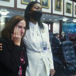 
              Rep. Robin Bartleman, D-Weston wipes tears from her eyes as she is hugged by Rep. Anika Omphroy, D-Lauderdale Lakes as debate stops for an on-floor protest by Democrats on Senate Bill 2-C: Establishing the Congressional Districts of the State in the House of Representatives, Thursday, April 21, 2022 at the Capitol in Tallahassee, Fla. The session was halted on the protest. (AP Photo/Phil Sears)
            