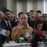 
              Pakistan's opposition leader Shahbaz Sharif talks to reporters outside the Supreme Court prior to a petition hearing for dissolving parliament by country's Prime Minister, in Islamabad, Pakistan, Tuesday, April 5, 2022. Pakistan's top court began hearing arguments Monday on whether Prime Minister Imran Khan and his allies had the legal right to dissolve parliament and set the stage for early elections. (AP Photo/Anjum Naveed)
            