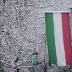 
              Elections posters and the Hungarian flag are seen outside a polling station for general election in Budapest, Hungary, Sunday, April 3, 2022. Hungary's nationalist prime minister, Viktor Orban, seeks a fourth straight term in office, a coalition of opposition parties are framing the election as a referendum on Hungary's future in the West. (AP Photo/Petr David Josek)
            