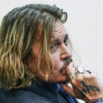 
              Actor Johnny Depp sits in the courtroom at the Fairfax County Circuit Courthouse in Fairfax, Va., Thursday, April 14, 2022.  Depp sued his ex-wife Amber Heard for libel in Fairfax County Circuit Court after she wrote an op-ed piece in The Washington Post in 2018 referring to herself as a “public figure representing domestic abuse.” (Shawn Thew/Pool Photo via AP)
            