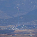
              A North Korean flag flutters in the wind atop a 160-meter tower in North Korea's village Gijungdong, as seen from the unification observatory in Paju, South Korea, Friday, April 15, 2022. North Korea is marking a key state anniversary Friday with calls for stronger loyalty to leader Kim Jong Un, but there was no word on an expected military parade to display new weapons amid heightened animosities with the United States. (AP Photo/Lee Jin-man)
            