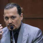 
              Actor Johnny Depp testifies during a hearing in the courtroom at the Fairfax County Circuit Court in Fairfax, Va., Wednesday, April 20, 2022. Actor Johnny Depp sued his ex-wife Amber Heard for libel in Fairfax County Circuit Court after she wrote an op-ed piece in The Washington Post in 2018 referring to herself as a "public figure representing domestic abuse." (Evelyn Hockstein/Pool via AP)
            