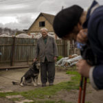 
              Petro Volin'ko, 87, attends the funeral of his neighbour Mykola Moroz, 47, at his home at the Ozera village, near Bucha, Ukraine on Tuesday, April 26, 2022. Mykola was captured by Russian army from his house in the Ozera village on March 13, taken for several weeks in an unknown location and finally found killed with gunshots about 15 kilometres from his house. (AP Photo/Emilio Morenatti)
            