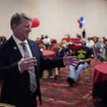 
              FILE - Jim Marchant meets with people at a Republican election night watch party, Tuesday, Nov. 3, 2020, in Las Vegas. Add one more contest to the white-hot races for Congress and governor that will dominate this year's midterm elections: secretaries of state. Former President Donald Trump's attempts to reverse the results of the 2020 election and his subsequent endorsements of candidates for state election offices who are sympathetic to his view have elevated those races to top-tier status.  (AP Photo/John Locher, File)
            