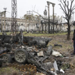 
              A Ukrainian saper examines a destroyed Russian military vehicle in Bucha, Ukraine, Tuesday, Apr. 5, 2022. Ukraine’s president told the U.N. Security Council on Tuesday that the Russian military must be brought to justice immediately for war crimes, accusing invading troops of the worst atrocities since World War II. He stressed that Bucha was only one place and there are more with similar horrors. (AP Photo/Efrem Lukatsky)
            