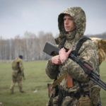 
              A Ukrainian soldier stands as sappers search for mines left by the Russian troops in the fields at the village of Berezivka, Ukraine, Thursday, April 21, 2022. (AP Photo/Efrem Lukatsky)
            