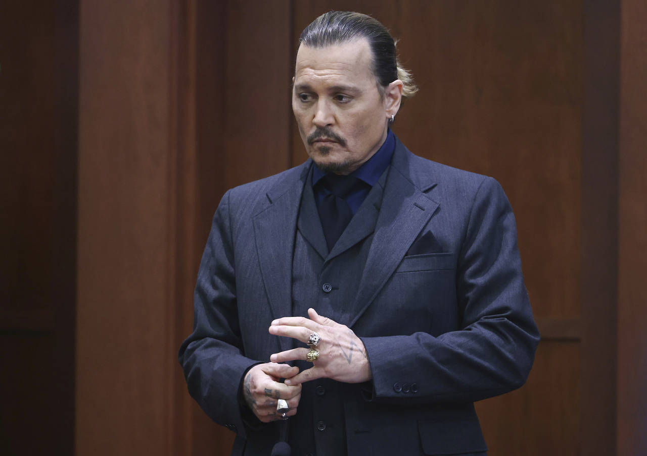 Actor Johnny Depp stands in the courtroom at the Fairfax County Circuit Court in Fairfax, Va., Thur...