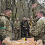 
              A Ukrainian army chaplain blesses soldiers on Easter eve at a military position outside Kyiv, Ukraine, Saturday, Apr. 23, 2022. (AP Photo/Efrem Lukatsky)
            
