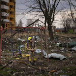 
              A firefighter sits on a swing next to a building destroyed by a Russian bomb in Chernihiv on Friday, April 22, 2022. (AP Photo/Emilio Morenatti)
            