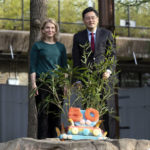 Zoo Director Brandie Smith and Chinese Ambassador to the U.S. Qin Gang poses with the fruitsicle cake during the celebration of the Smithsonian's National Zoo and Conservation Biology Institute, 50 years of achievement in the care, conservation, breeding and study of giant pandas at the Smithsonian's National Zoo in Washington, Saturday, April 16, 2022. (AP Photo/Jose Luis Magana)