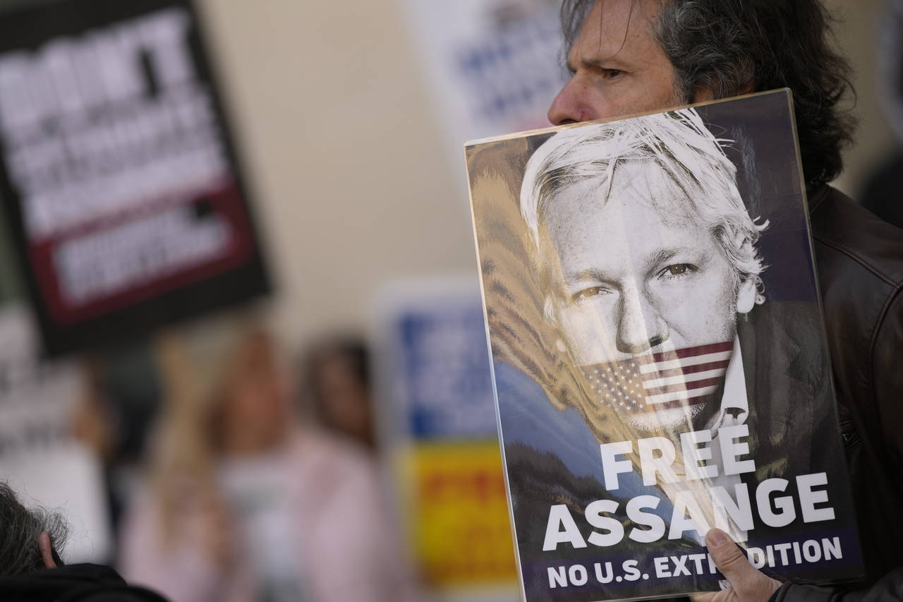 Wikileaks founder Julian Assange supporters hold placards as they gather outside Westminster Magist...