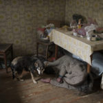 
              A dog stands next to the body of an elderly woman killed inside a house in Bucha, outskirts of Kyiv, Ukraine, Tuesday, April 5, 2022. (AP Photo/Felipe Dana)
            