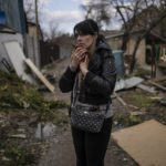 
              Ira Gavriluk holds her cat outside her house, where his husband and brother were killed, in Bucha, on the outskirts of Kyiv, Ukraine, Monday, April 4, 2022. Russia is facing a fresh wave of condemnation after evidence emerged of what appeared to be deliberate killings of civilians in Ukraine. (AP Photo/Rodrigo Abd)
            