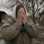 
              Tetiana Oleksiienko cries standing at the gate of her house in the village of Andriivka, Ukraine, heavily affected by fighting between Russian and Ukrainian forces, Wednesday, April 6, 2022. (AP Photo/Vadim Ghirda)
            