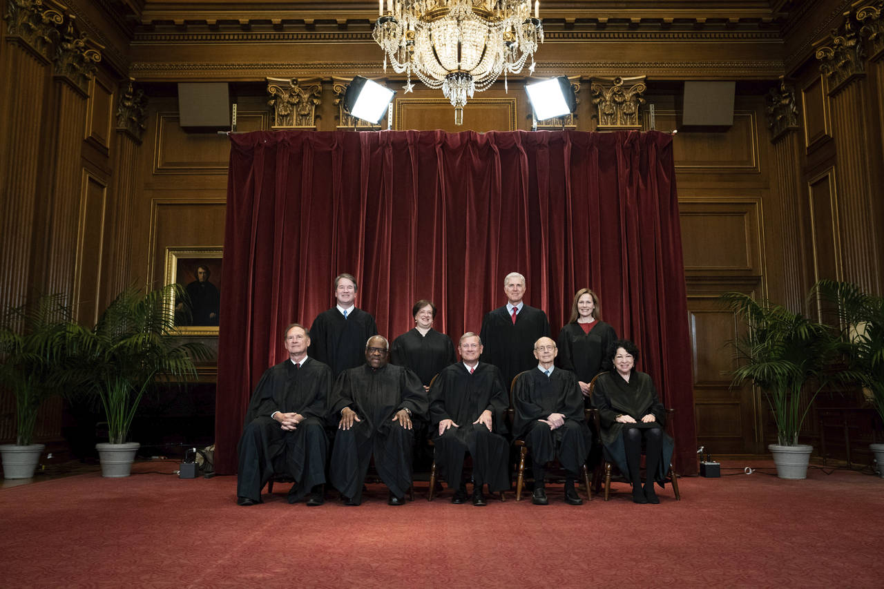 FILE - Members of the Supreme Court pose for a group photo at the Supreme Court in Washington, Apri...