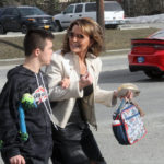 
              Former Alaska Gov. Sarah Palin arrives for the opening of her new campaign headquarters in Anchorage, Alaska, with her son, Trig, on Wednesday, April 20, 2022. Palin, the first Republican female vice presidential nominee, is among 48 candidates running for the Alaska's lone seat in the U.S. House following the death last month of Republican Rep. Don Young, who held the job for 49 years. (AP Photo/Mark Thiessen)
            