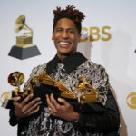 
              Jon Batiste, winner of the awards for best American roots performance for "Cry," best American roots song for "Cry," best music video for "Freedom," best score soundtrack for visual media for "Soul," and album of the year for "We Are," poses in the press room at the 64th Annual Grammy Awards at the MGM Grand Garden Arena on Sunday, April 3, 2022, in Las Vegas. (AP Photo/John Locher)
            