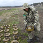 
              An interior ministry sapper collects mines on a mine field after recent battles in Irpin close to Kyiv, Ukraine, Tuesday, April 19, 2022. (AP Photo/Efrem Lukatsky)
            