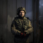 
              Vadym Kovalyov, 29, entrepreneur and actor, poses for a photo at a military base for volunteers in Brovary, on the outskirts of Kyiv, Ukraine, Wednesday, March 30, 2022. Like many of the volunteer fighters, Kovalyov never expected to go to war. "These people, my brothers, they are in the right place," he said. "They made the right choice not to go abroad. They stayed with the people and on our land to defend it." (AP Photo/Felipe Dana)
            