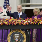 
              President Joe Biden and first lady Jill Biden, walk out to participate in activities during the White House Easter Egg Roll, Monday, April 18, 2022, at The White House in Washington. (AP Photo/Susan Walsh)
            