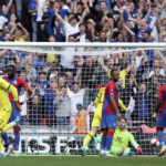 
              Crystal Palace players react after Chelsea's Ruben Loftus-Cheek, foreground left, scored the opening goal during the English FA Cup semifinal soccer match between Chelsea and Crystal Palace at Wembley stadium in London, Sunday, April 17, 2022. (AP Photo/Ian Walton)
            