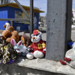 
              Flowers and toys were left on a fence at the railway station in Kramatorsk, Ukraine, Monday, April 11, 2022. A missile strike killed at least 50 people and wounded dozens more when a rocket hit the railway station on Friday, April 8. (AP Photo/Andriy Andriyenko)
            