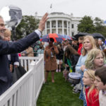 
              Hunter Biden, left, the son of President Joe Biden, holds his son, Beau Biden, and waves to people in the audience during the White House Easter Egg Roll on the South Lawn of the White House, Monday, April 18, 2022, in Washington. (AP Photo/Andrew Harnik)
            