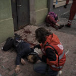 
              Emergency workers help injured civilians during a Russian bombardment in Kharkiv, Ukraine, Sunday, April 17, 2022. (AP Photo/Felipe Dana)
            