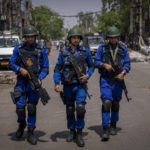 
              Indian paramilitary soldiers patrol during the demolition of Muslim-owned shops at the site of Saturday's violence in New Delhi's northwest Jahangirpuri neighborhood, in New Delhi, India, Wednesday, April 20, 2022. Authorities riding bulldozers razed a number of Muslim-owned shops in New Delhi before India's Supreme Court halted the demolitions Wednesday, days after communal violence shook the capital and saw dozens arrested. (AP Photo/Altaf Qadri)
            