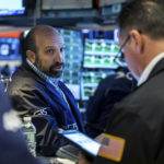 
              In this photo provided by the New York Stock Exchange, specialist James Denaro works with traders at his post on the floor, Wednesday, April 27, 2022. Stocks shook off a wobbly start and gained ground in late morning trading on Wall Street Wednesday, after a big sell-off of tech stocks a day earlier. It's the latest turbulence for the market as traders brace for more earnings reports from major U.S. companies this week. (Courtney Crow/New York Stock Exchange via AP)
            