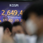 
              Currency traders watch computer monitors near the screen showing the Korea Composite Stock Price Index (KOSPI) at a foreign exchange dealing room in Seoul, South Korea, Thursday, April 28, 2022. (AP Photo/Lee Jin-man)
            