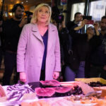 
              French far-right leader Marine Le Pen tours a food market in Narbonne, southern France, Friday, April 8, 2022. France's first round of the presidential election will take place on April 10, with a presidential runoff on April 24 if no candidate wins outright. (AP Photo/Joan Mateu Parra)
            