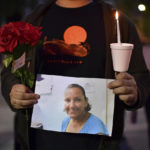 
              A person who did not want to be identified holds a photograph of Melinda Davis, 57, during a candlelight vigil held at Ali Youssefi Square in Sacramento, Calif., late Monday, April 4, 2022. Davis was one of the people killed after a shooting that occurred early Sunday. (Jose Carlos Fajardo/Bay Area News Group via AP)
            