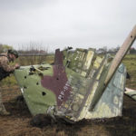
              A Ukrainian soldier examines a fragment of a Russian Air Force Su-25 jet after a recent battle at the village of Kolonshchyna, Ukraine, Thursday, April 21, 2022.(AP Photo/Efrem Lukatsky)
            
