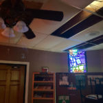 
              This Sept. 2021, photo provided the Rev. Rajasekar Karumelnathan, shows missing ceiling tiles and water damage on the inside of St. Charles Borromeo Catholic church located in Point-aux-Chenes, La. The church, which was badly damaged when Hurricane Ida made landfall in late August 2021 now celebrates Mass in the rectory, or under a tent set up in the church park lot. (Rev. Rajasekar Karumelnathan via AP)
            
