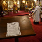 
              A Prayer for Ukraine is displayed on a stand during Easter Morning Devine Services at Transfiguration of Our Lord Ukrainian Catholic Church in Shamokin, Pa., Sunday, April 17, 2022. (AP Photo/Carolyn Kaster)
            