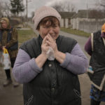 
              A woman cries while waiting along with others for distribution of food products in the village of Motyzhyn, Ukraine, which was until recently under the control of the Russian military, Sunday, April 3, 2022. (AP Photo/Vadim Ghirda)
            